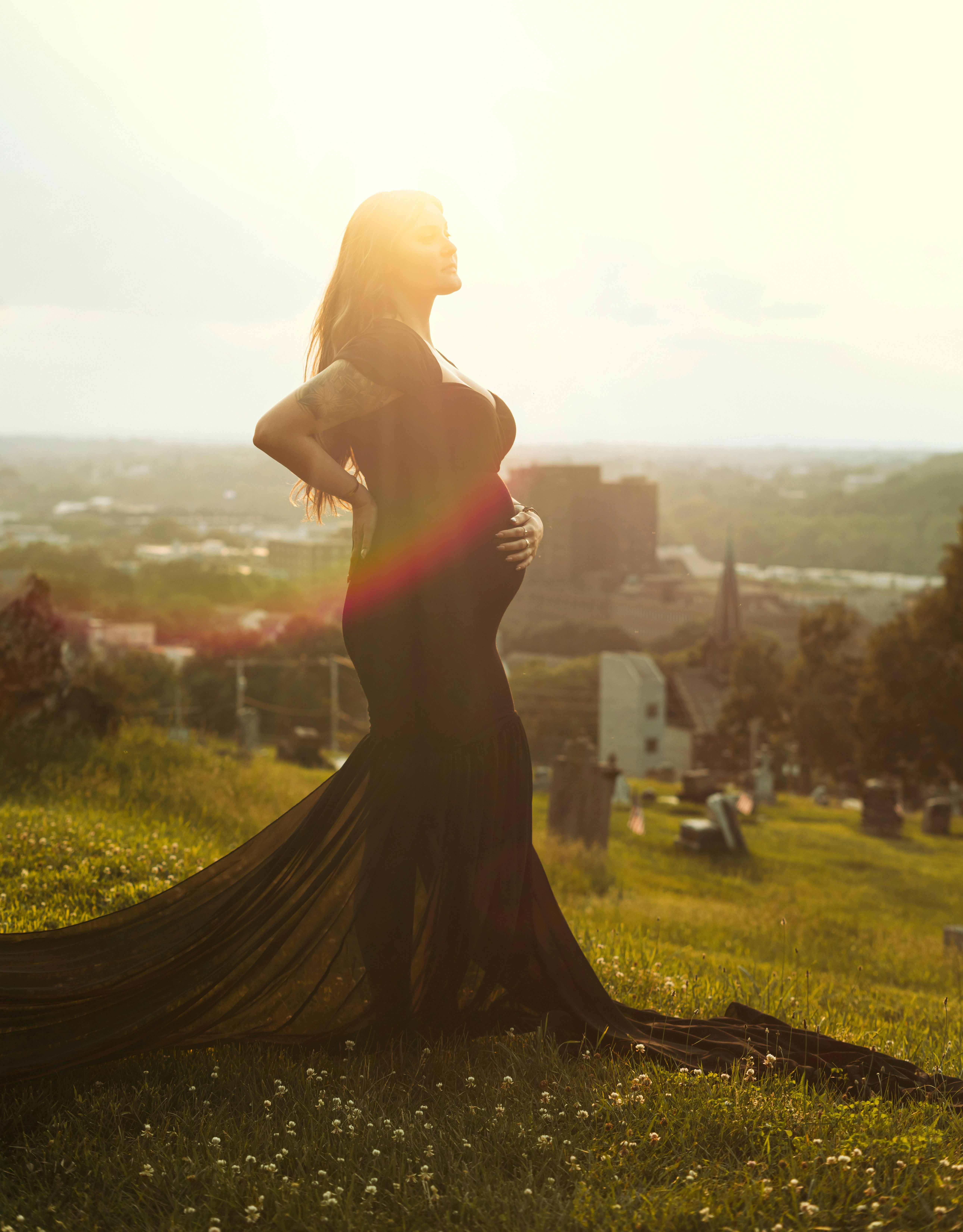 woman in black dress standing on green grass field during daytime